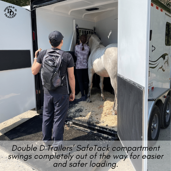 Double D Trailer owner loading their horse in a slant load model with the SafeTack compartment in the open position; allowing for a completely clear loading/unloading zone.